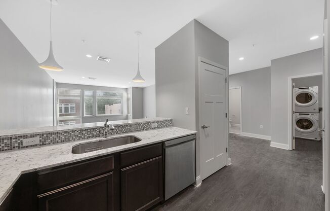Renovated 1 bedroom with laundry in unit! Granite countertops, tiled bathroom, hardwood floors, off street parking & MORE!