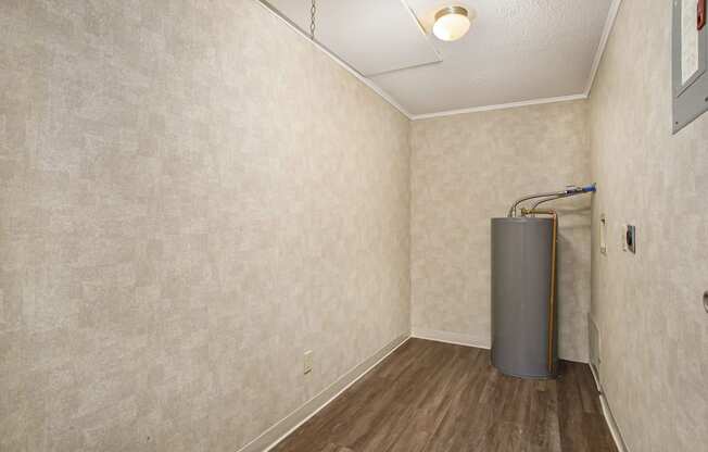 a room with a water heater in the corner