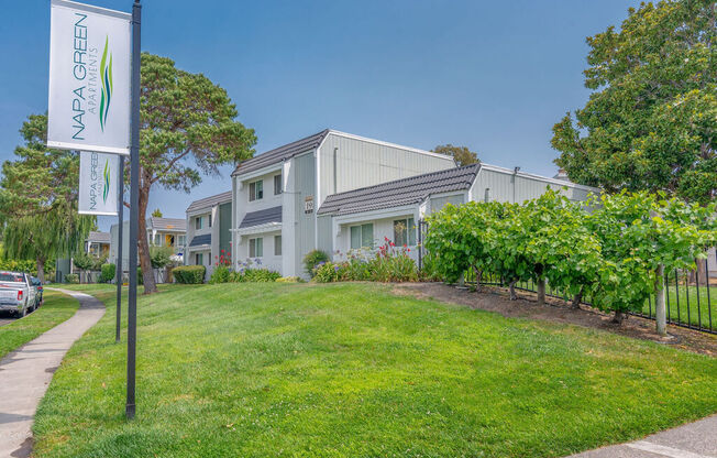 a house with a yard and a sign in front of it