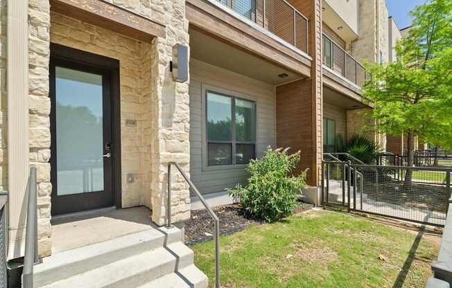 A building with a stone pillar and glass door.