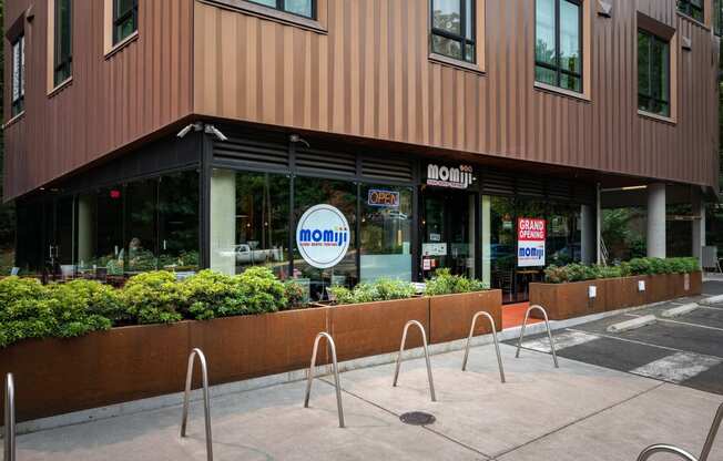 a sidewalk in front of a building with a noon sign