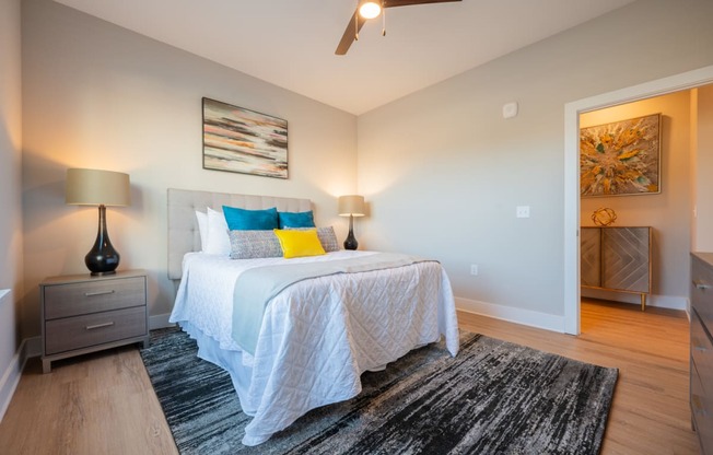 a bedroom with a bed and a ceiling fan