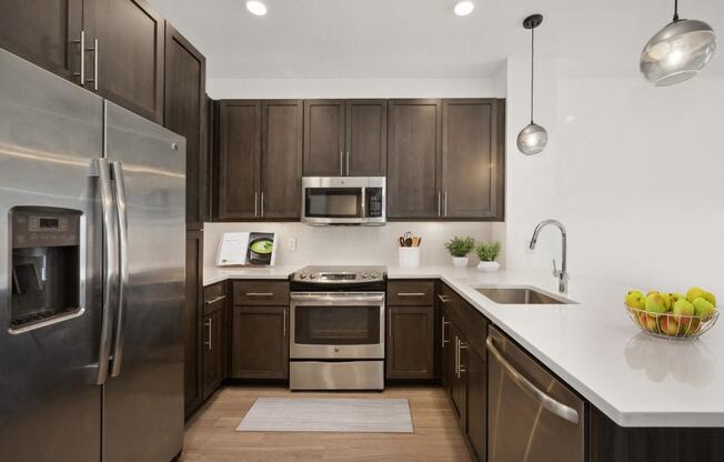 a kitchen with stainless steel appliances and wooden cabinets