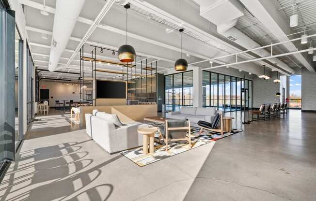 a large living room with couches and chairs and a tv