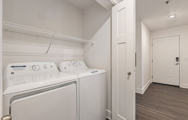 a washer and dryer in a laundry room  at Signature Pointe Apartment Homes, Athens, 35611