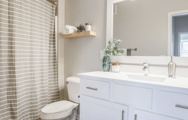 Bathroom with white cabinetry at Ascend at Woodbury new luxury apartments in Woodbury MN 55129