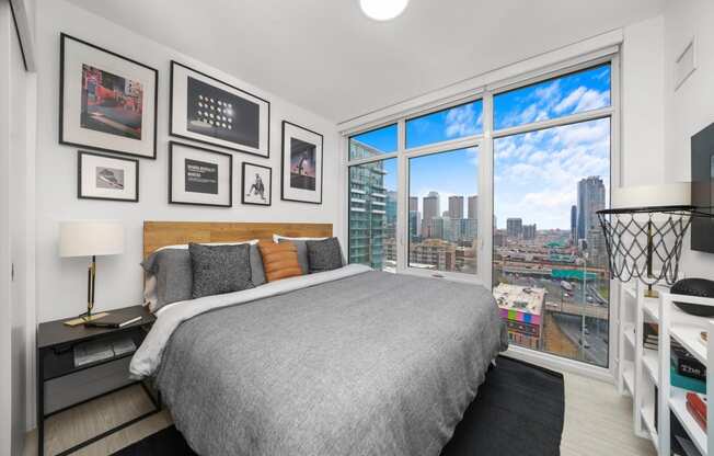 a bedroom with a bed and a view of the city