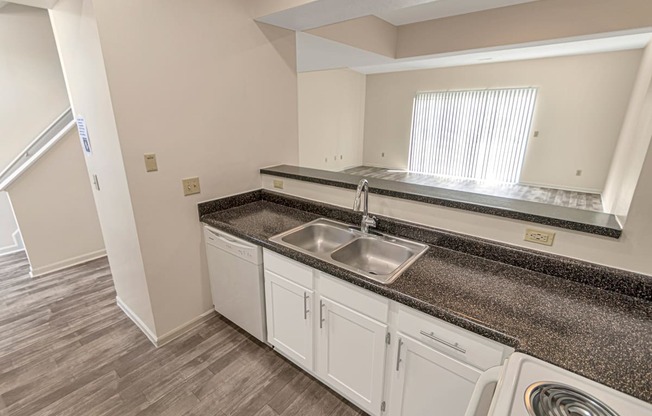 This is a photo of the kitchen of the 1280 square foot 2 bedroom, 2 and 1/2 bath Oakwood floor plan at Washington Park Apartments in Centerville, OH.