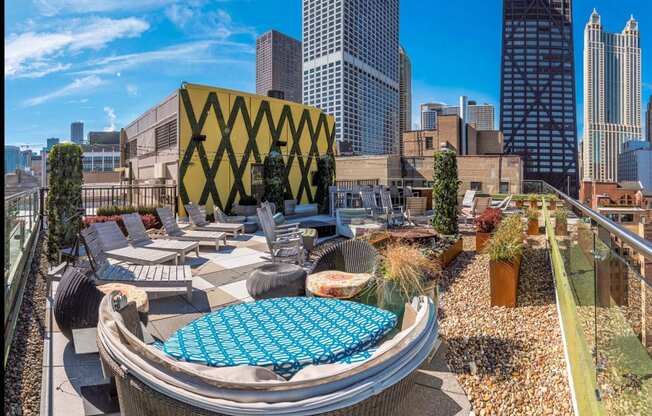 a rooftop lounge with a city skyline in the background