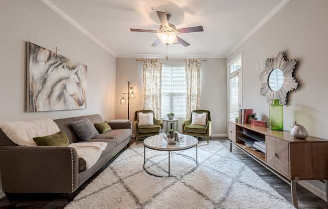 a living room with a ceiling fan and a couch