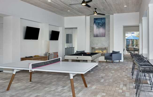 a games room with a ping pong table and a foosball table