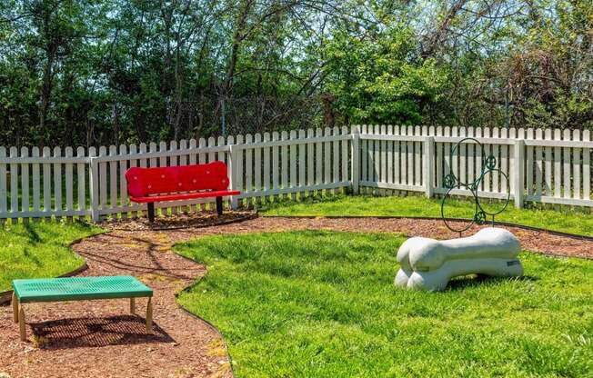 Drake's Creek Apartments - Retreat at Indian Lake - Fenced-In Outdoor Pet Park With Bench Seating and Obstacle Course Play Equipment on Lush Grass