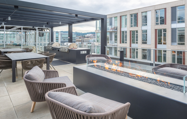 Rooftop sundeck with social seating and fire pit