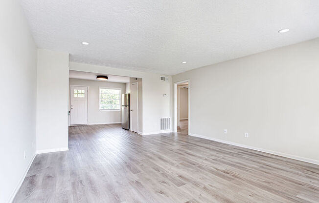 an empty living room with a hardwood floor  at The Oasis on Cascade, Atlanta, GA