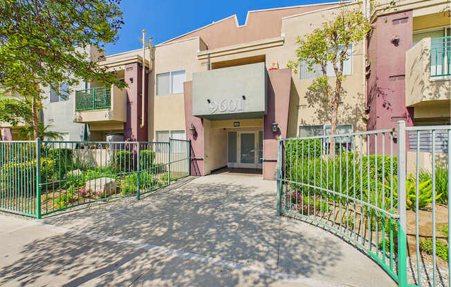 The entrance to a building with a green gate.