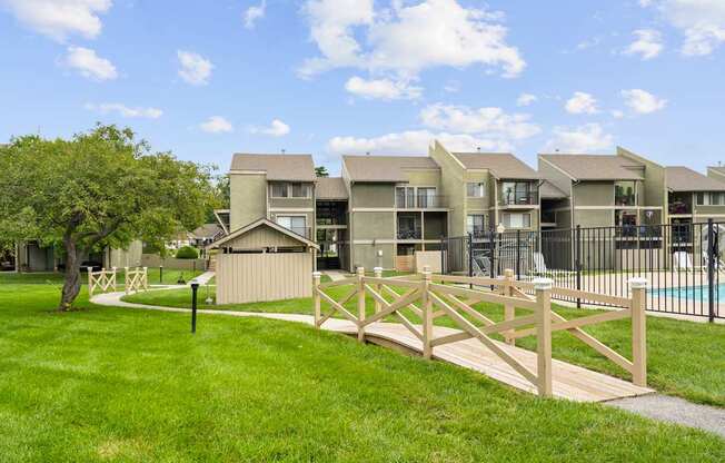 A row of houses with a wooden fence in front.