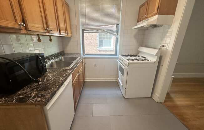 a small kitchen with a stove and a window