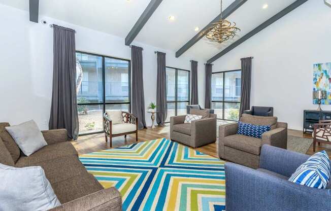 A living room with a colorful rug and two couches.