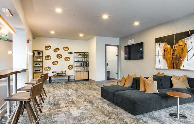 A modern living room with a grey sofa and a wooden coffee table.