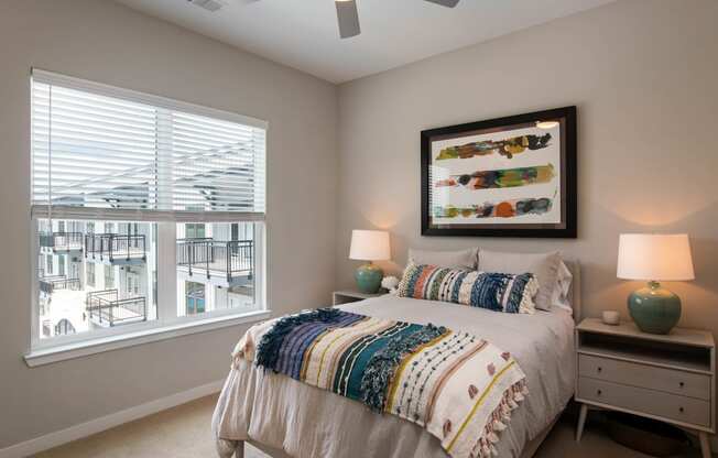 a bedroom with a large window and a bed at One Riverside Apartments, Chattanooga, TN, 37403