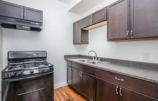 a kitchen with stainless steel appliances and wooden cabinets