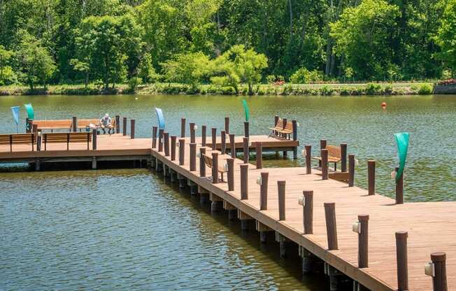 a dock on a lake with chairs on it