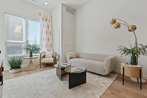 a living room with a couch and a table at SevenO2 Main Apartments, Utah, 84101