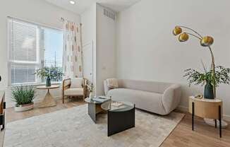 a living room with a couch and a table at SevenO2 Main Apartments, Utah, 84101