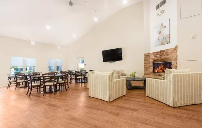 FountainGlen Temecula clubhouse with wood flooring and a fireplace