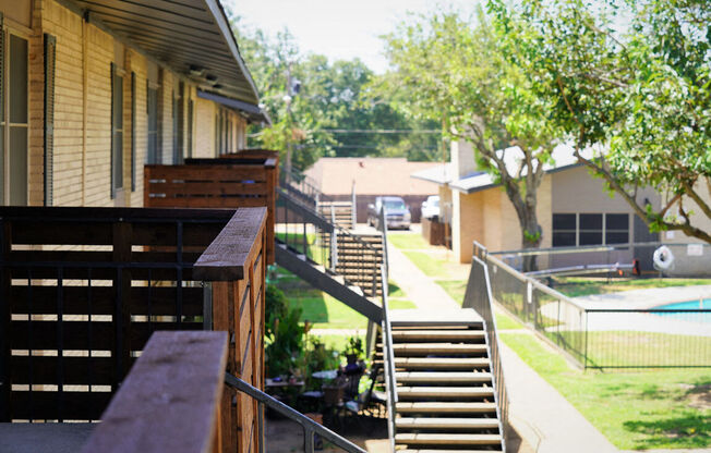 the backyard of a house with stairs and a pool