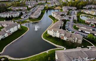 arial view of a subdivision with a lake and fountain