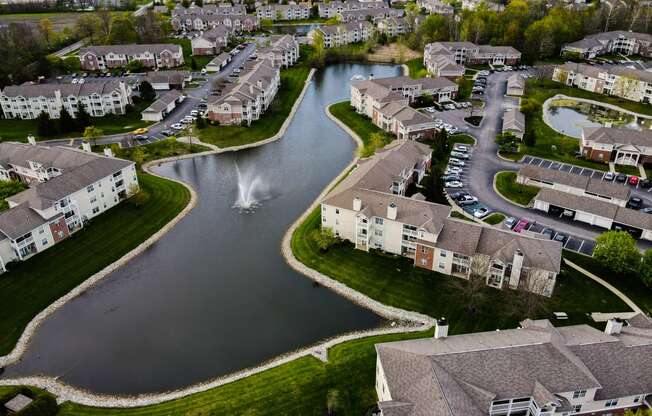 arial view of a subdivision with a lake and fountain