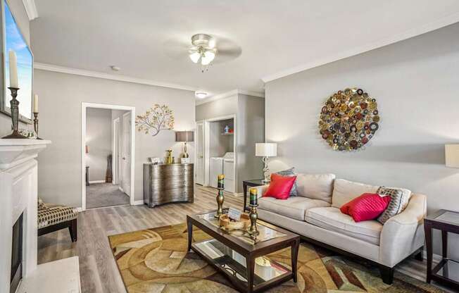 A living room with a white couch and a coffee table.