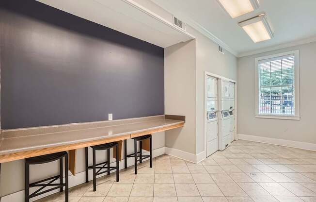 A kitchen with a counter and bar stools.