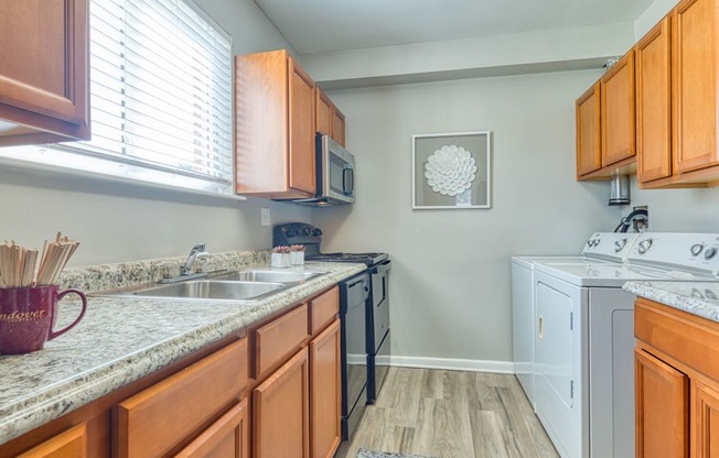 a kitchen with a counter top and a window