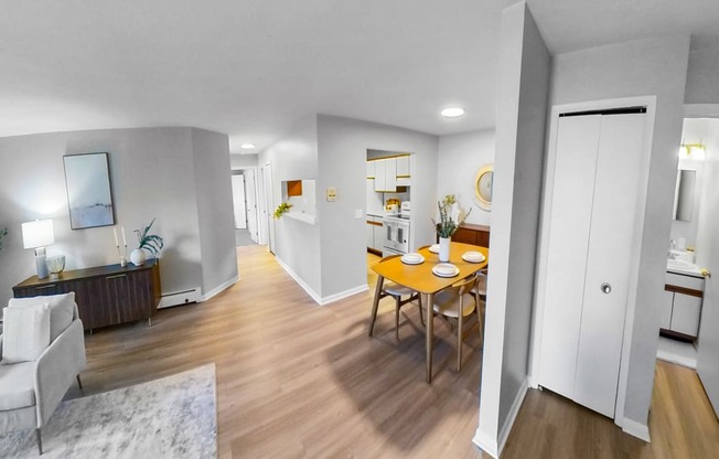 a living room and dining room with a table and chairs