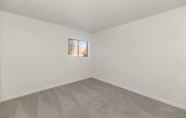 A room with a carpeted floor at Urban WalkApartments on 6th Avenue, Phoenix