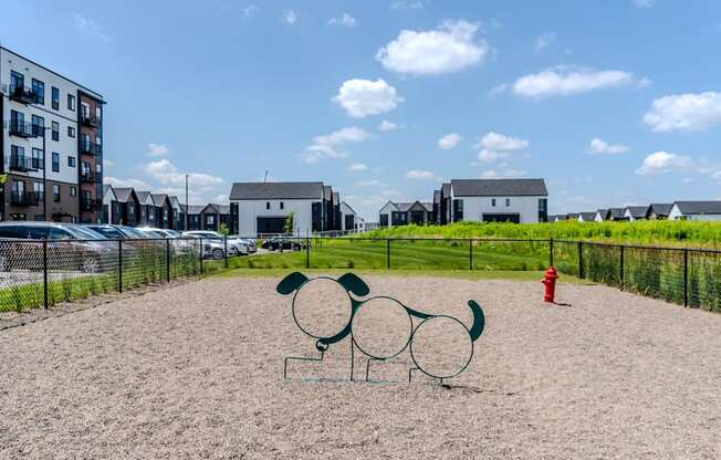 A playground with a Mickey Mouse sculpture in the middle of a sandy area.