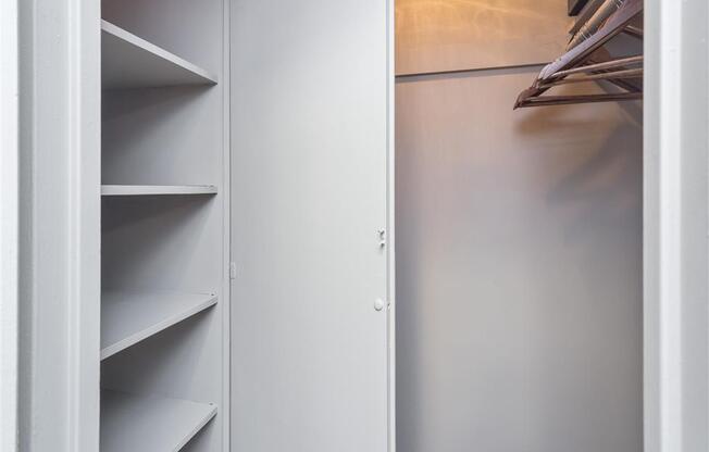 a white closet with white shelves and doors
