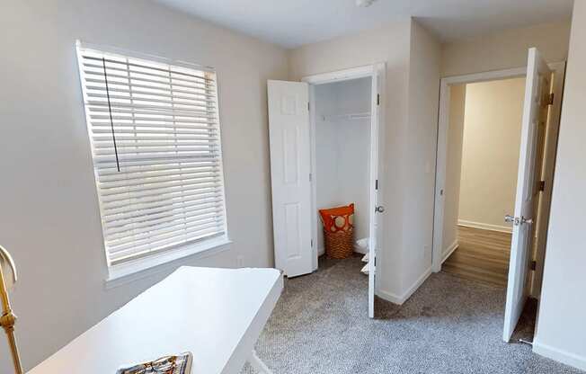 a room with a white table and a hallway with a door and a window