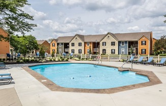 1 BR Apartments in Westerville, OH - Fairway Lakes - Sparkling Pool Surrounded By Lounge Chairs and the Apartment Buildings.