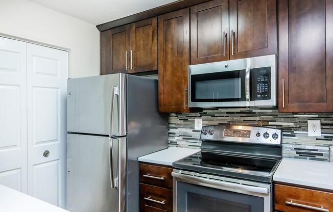 a stove top oven sitting inside of a kitchen