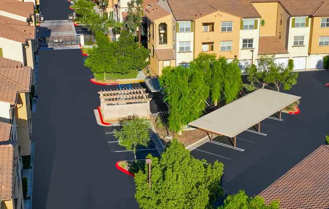 an aerial view of a parking lot with benches and trees