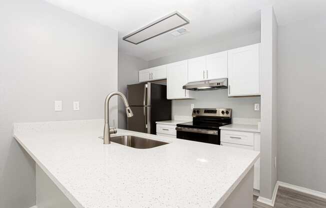 a kitchen with white counter tops and a sink at Parc at 1875, College Park, GA