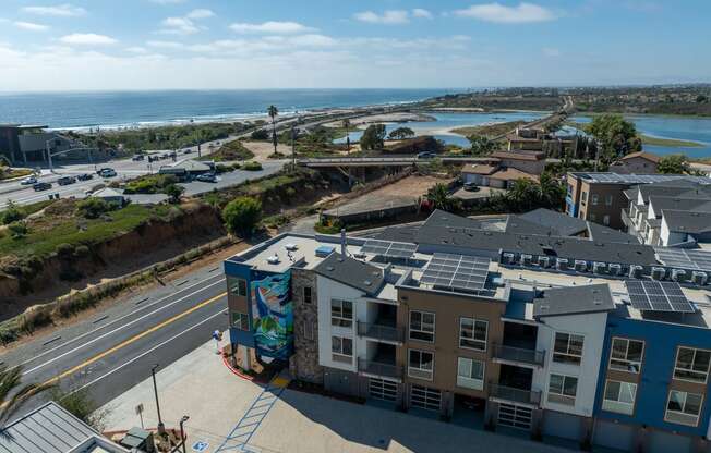 an aerial view of an apartment building with solar panels on the roof