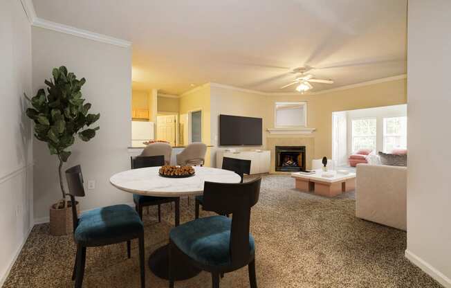 a living room with a round table and chairs and a fireplace