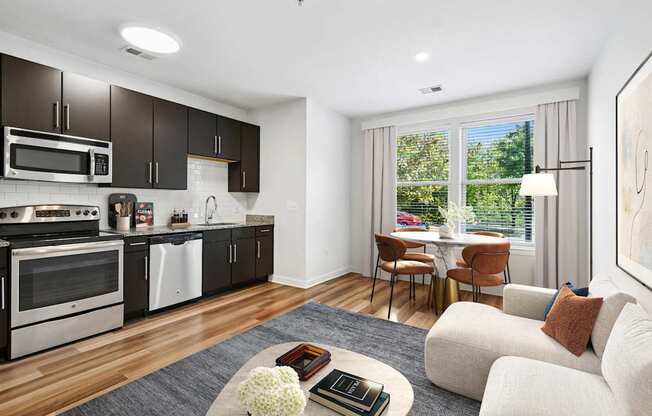 A modern kitchen with a dining area and a couch.