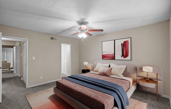 a bedroom with a bed and a ceiling fan