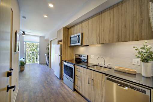 A kitchen with wooden cabinets and stainless steel appliances.
