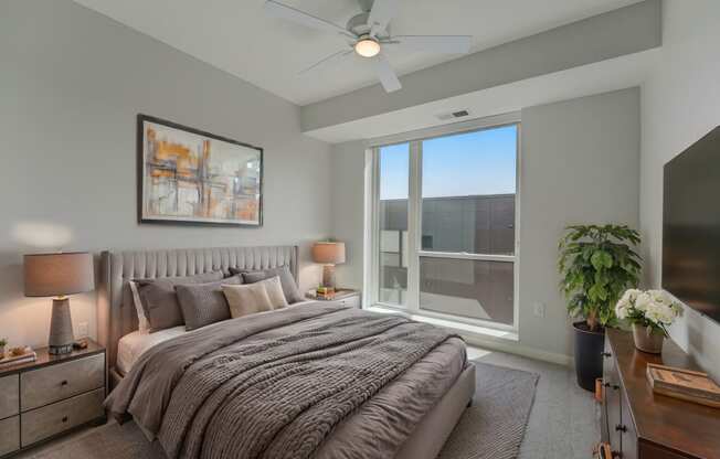 a bedroom with a large bed and a large window